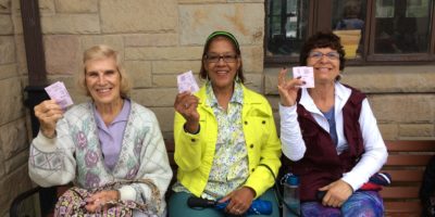 48122997691_3b7fa288e0_o Three women holding transit tickets and smiling
