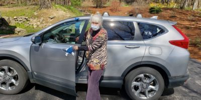 CVTC Linda Cleaning Up volunteer driver wearing face mask sanitizing car