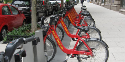 Photo of row of red bike share bikes in docking station in Washington, DC. Credit: R. Beyerle