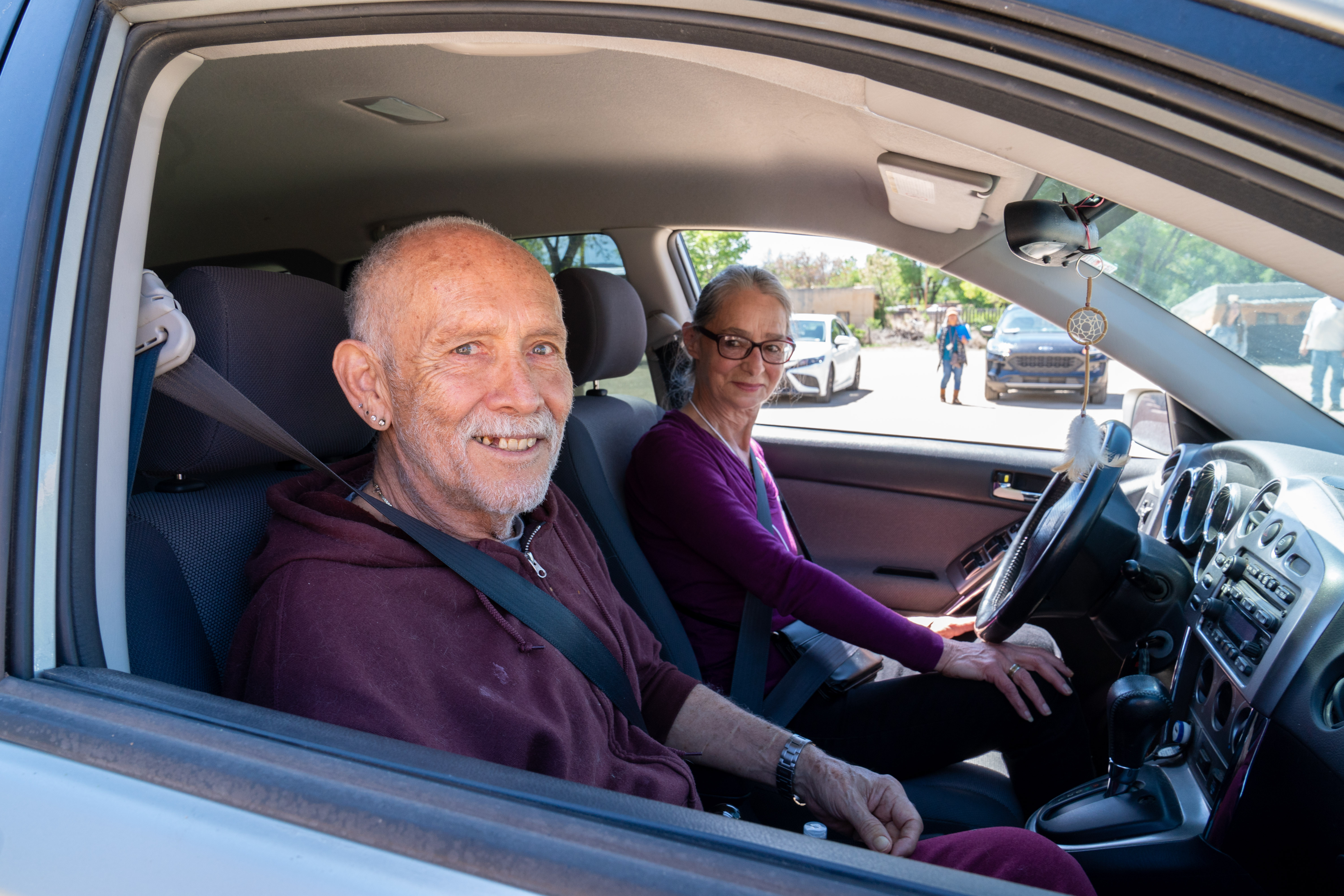 volunteer driver with older adult in front seat
