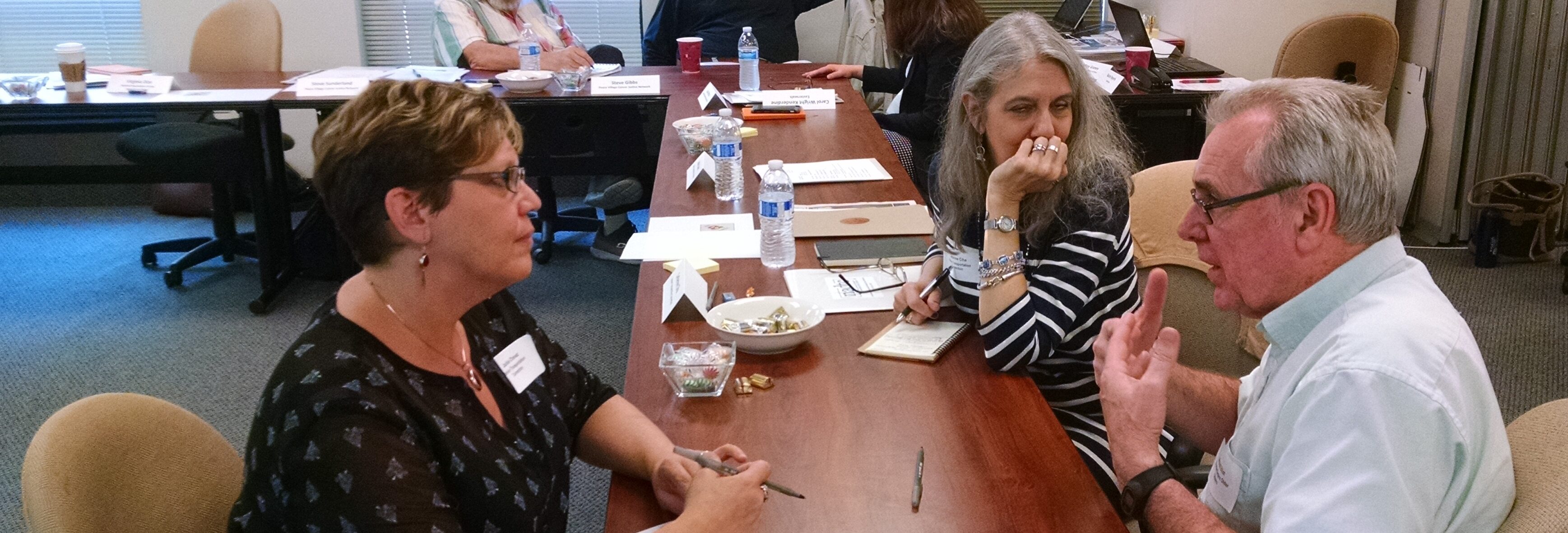People sitting around a conference table having a discussion