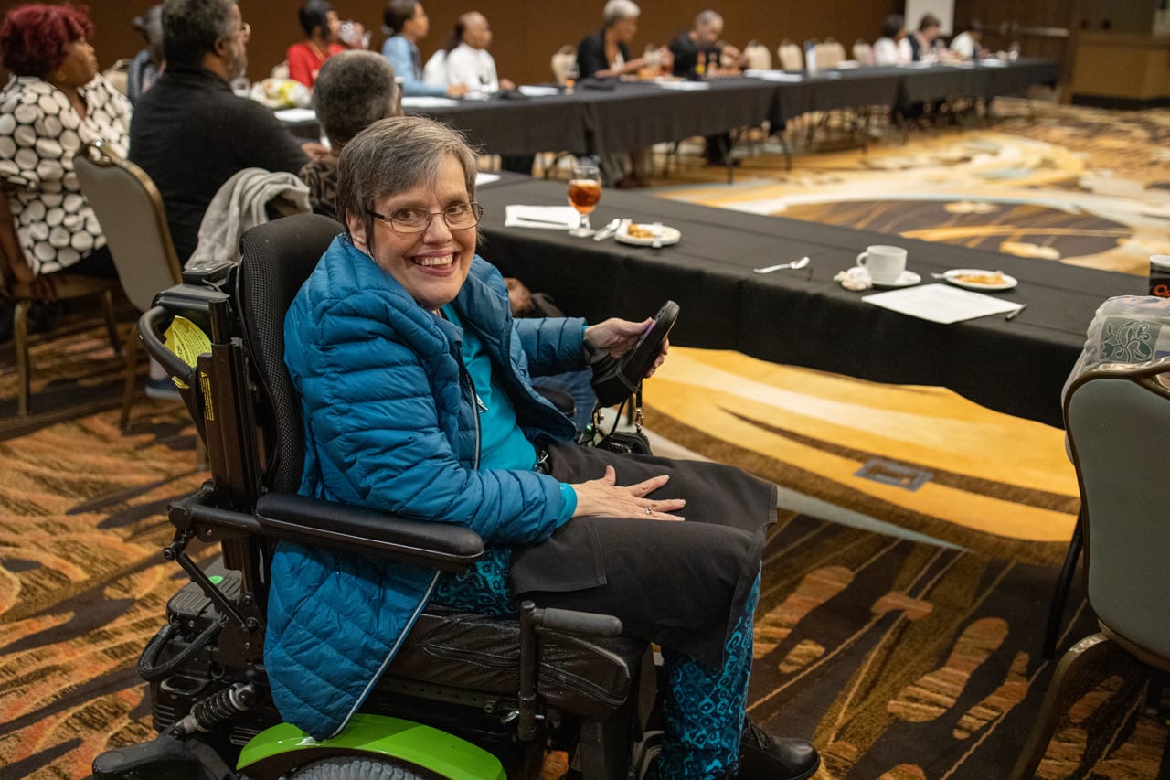 Woman in power wheelchair at planning meeting