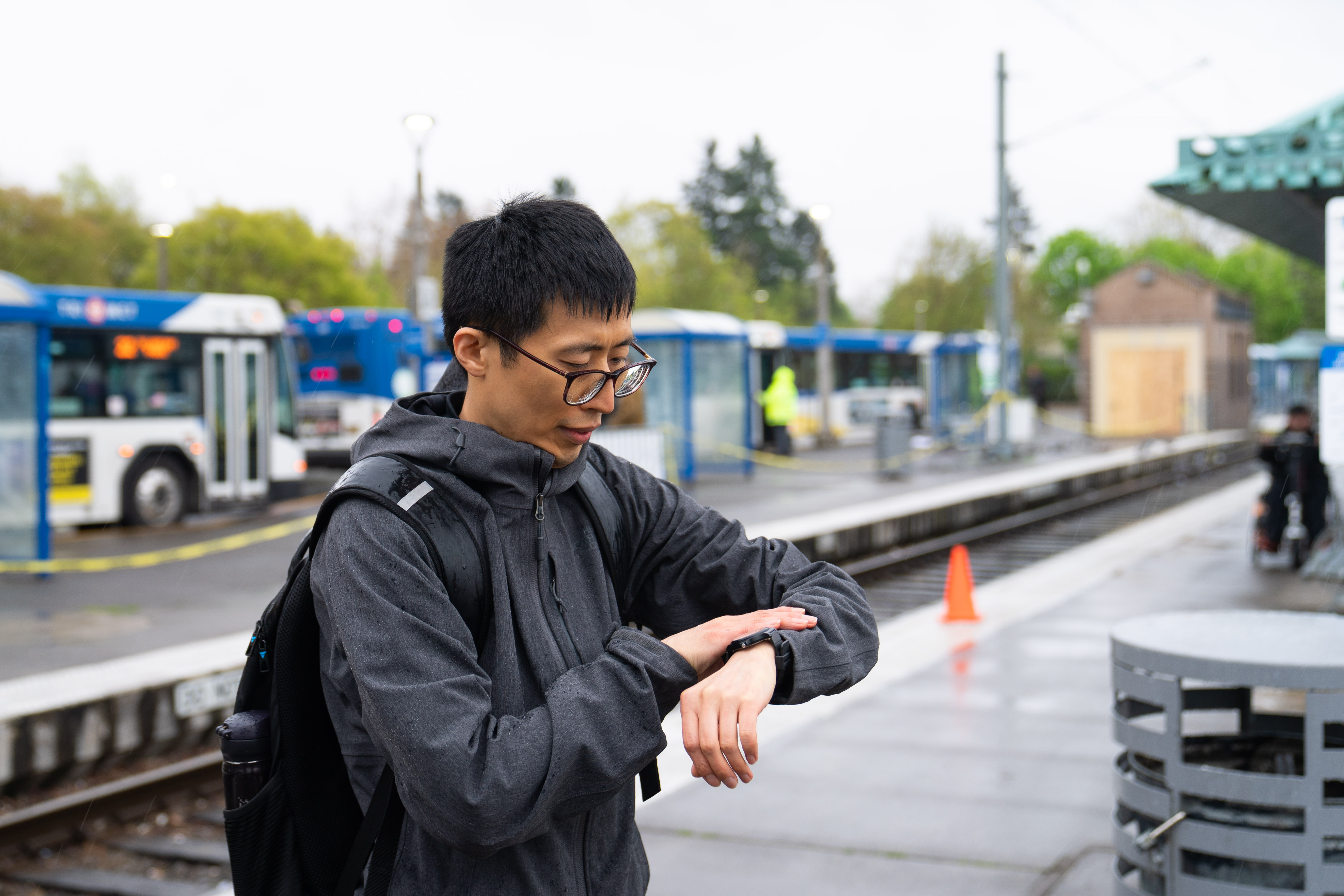 Man looks at watch waiting for train