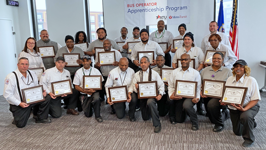 A diverse group of mentorship graduates pose with their certificates