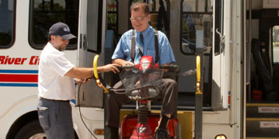 Man on scooter using paratransit van lift