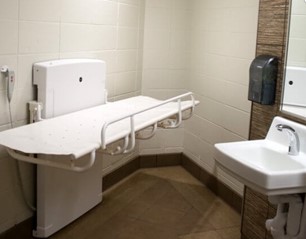 public restroom with adult changing table and sink