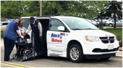 driver and caregiver assists man with walker into Rides to Wellness van