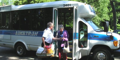 Transit driver assisting passenger off transit vehicle
