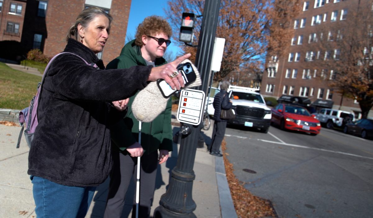 travel trainer and blind person on street