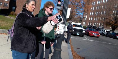 travel trainer and blind person on street