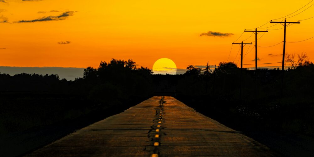highway facing a sunset