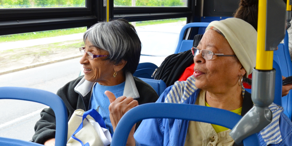 Two older women traveling by bus
